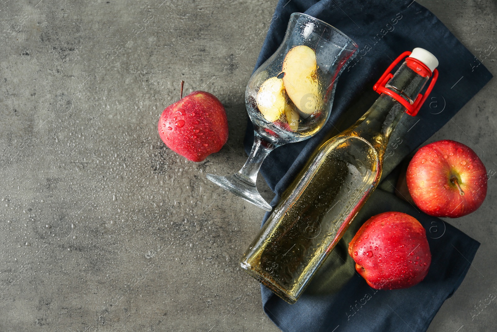 Photo of Flat lay composition with delicious apple cider on gray table, space for text