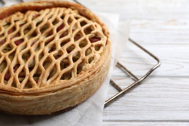 Freshly baked rhubarb pie on light wooden table, closeup. Space for text