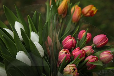 Photo of Beautiful bouquets of colorful tulips outdoors, closeup