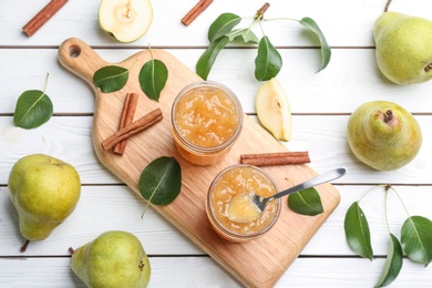 Delicious pear jam and fresh fruits on white wooden table, flat lay