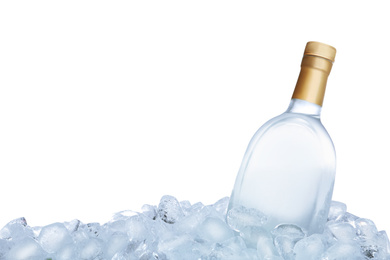 Ice cubes and bottle of vodka on white background