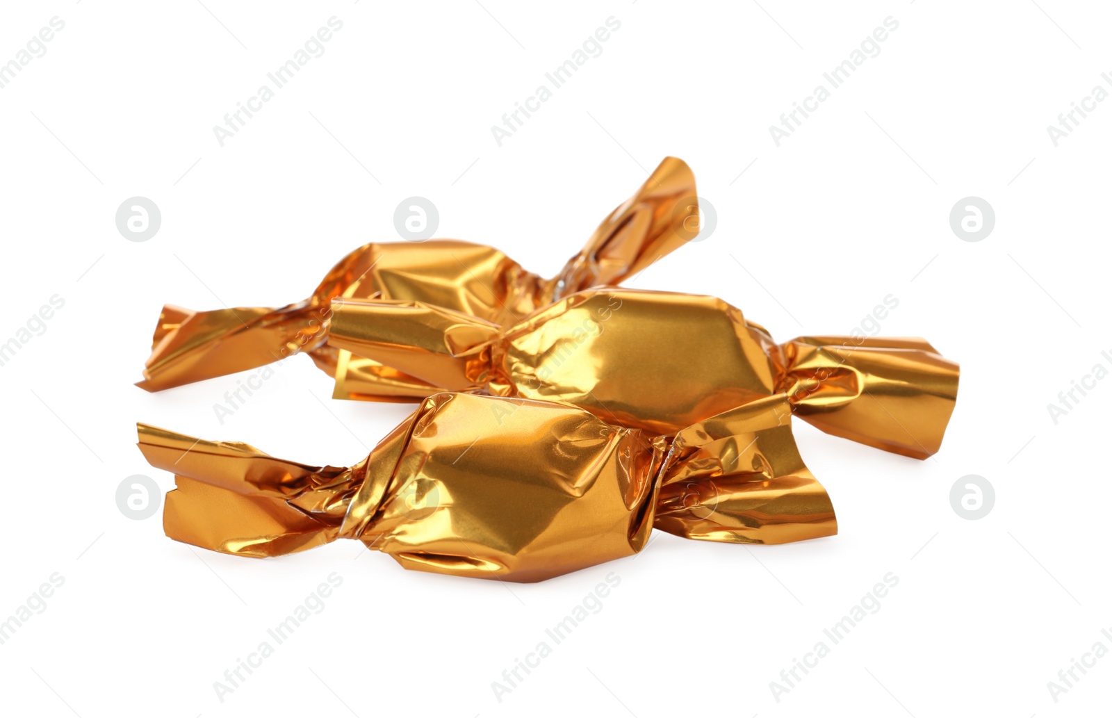 Photo of Delicious candies in golden wrappers on white background