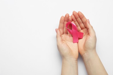 Photo of Breast cancer awareness. Woman with pink ribbon on white background, top view. Space for text