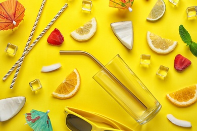 Photo of Flat lay composition with glass, sliced fruits and coconut on color background. Summer cocktail recipe