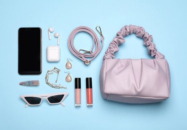 Photo of Flat lay composition with stylish woman's bag on turquoise background
