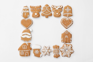 Photo of Frame made with different Christmas gingerbread cookies on white background, top view. Space for text