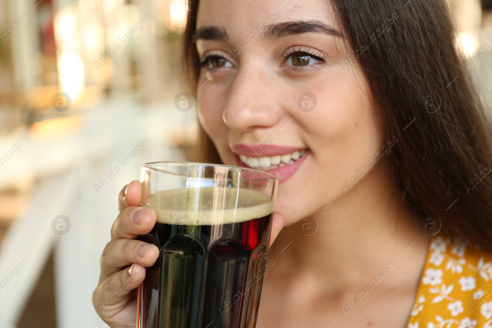 Photo of Beautiful woman with cold kvass outdoors, closeup. Traditional Russian summer drink