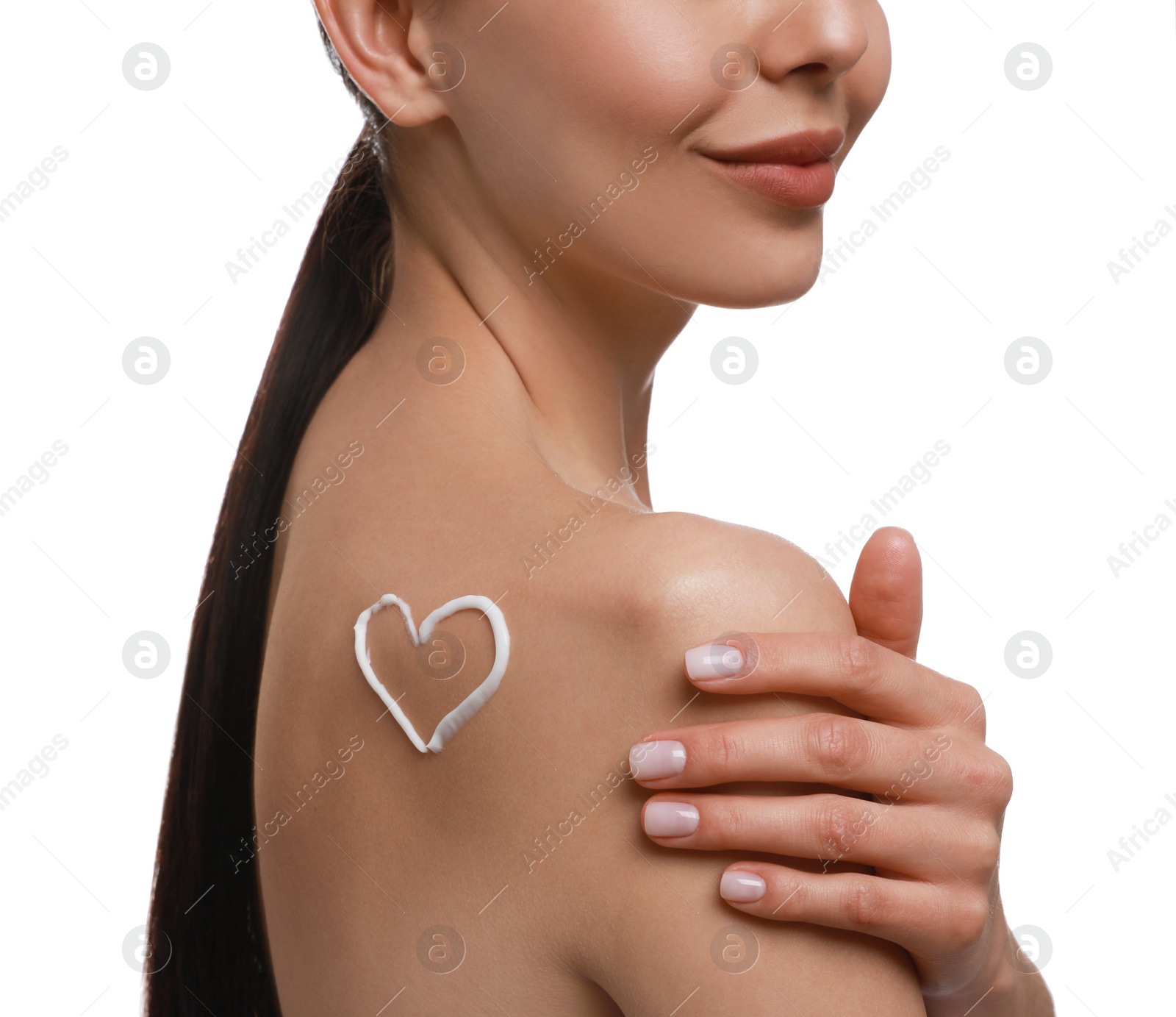 Photo of Young woman applying body cream onto her back against white background, closeup