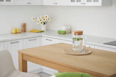 Photo of Stylish wooden table in beautiful kitchen interior