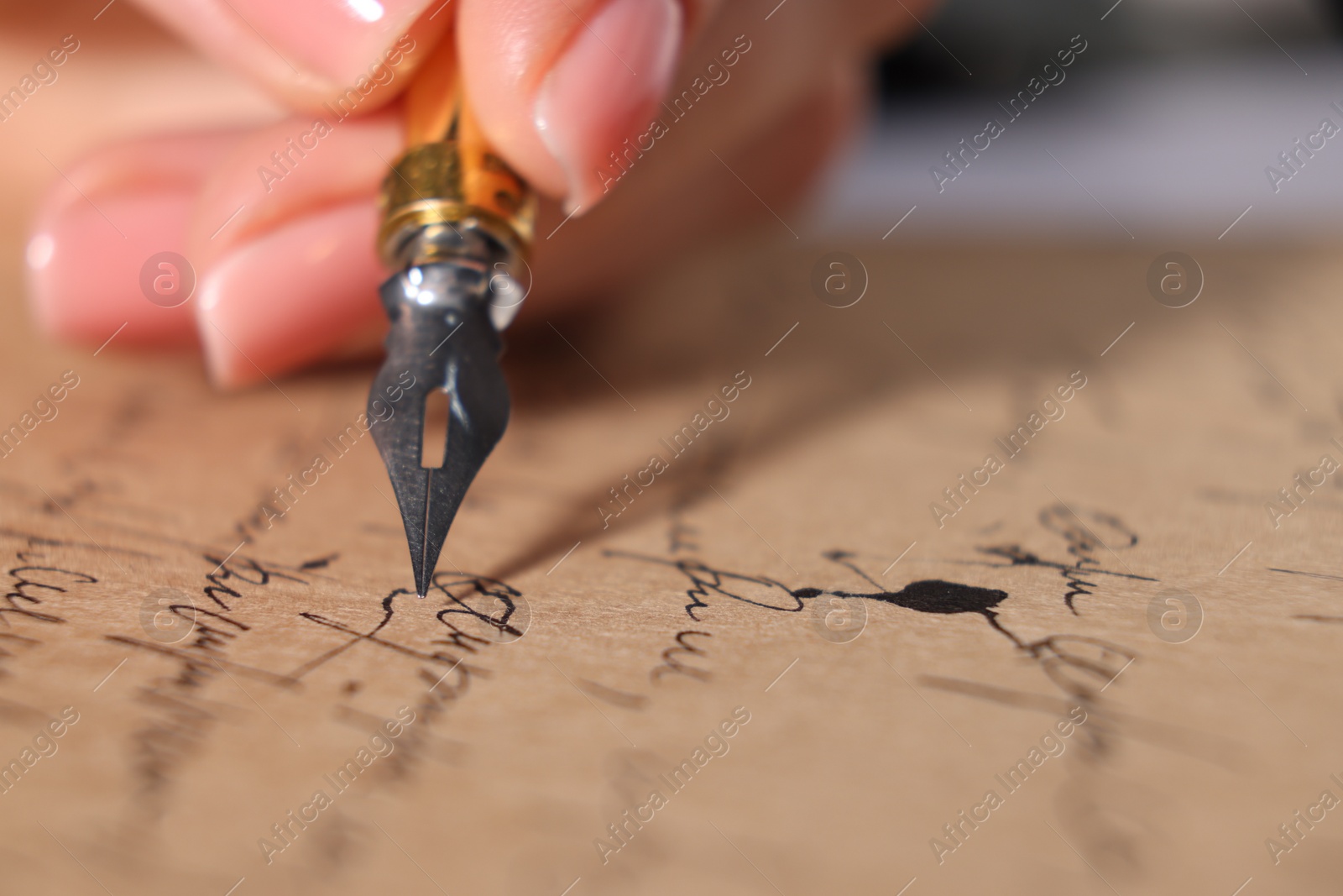 Photo of Woman writing letter with fountain pen, closeup