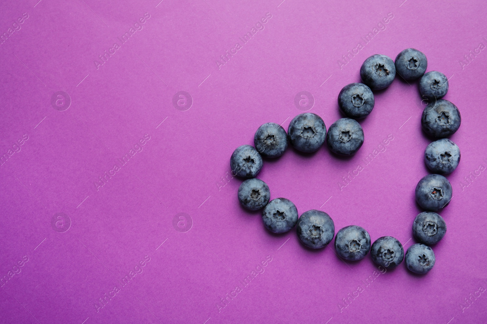 Photo of Flat lay composition with tasty blueberry and space for text on color background