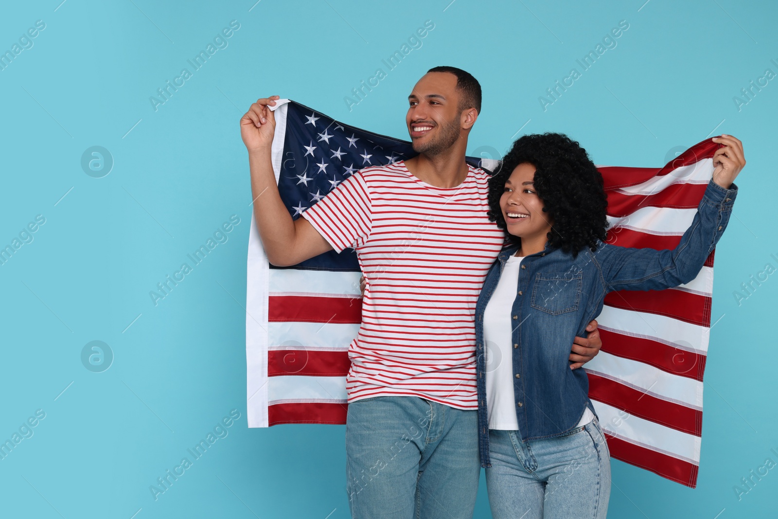 Photo of 4th of July - Independence Day of USA. Happy couple with American flag on light blue background