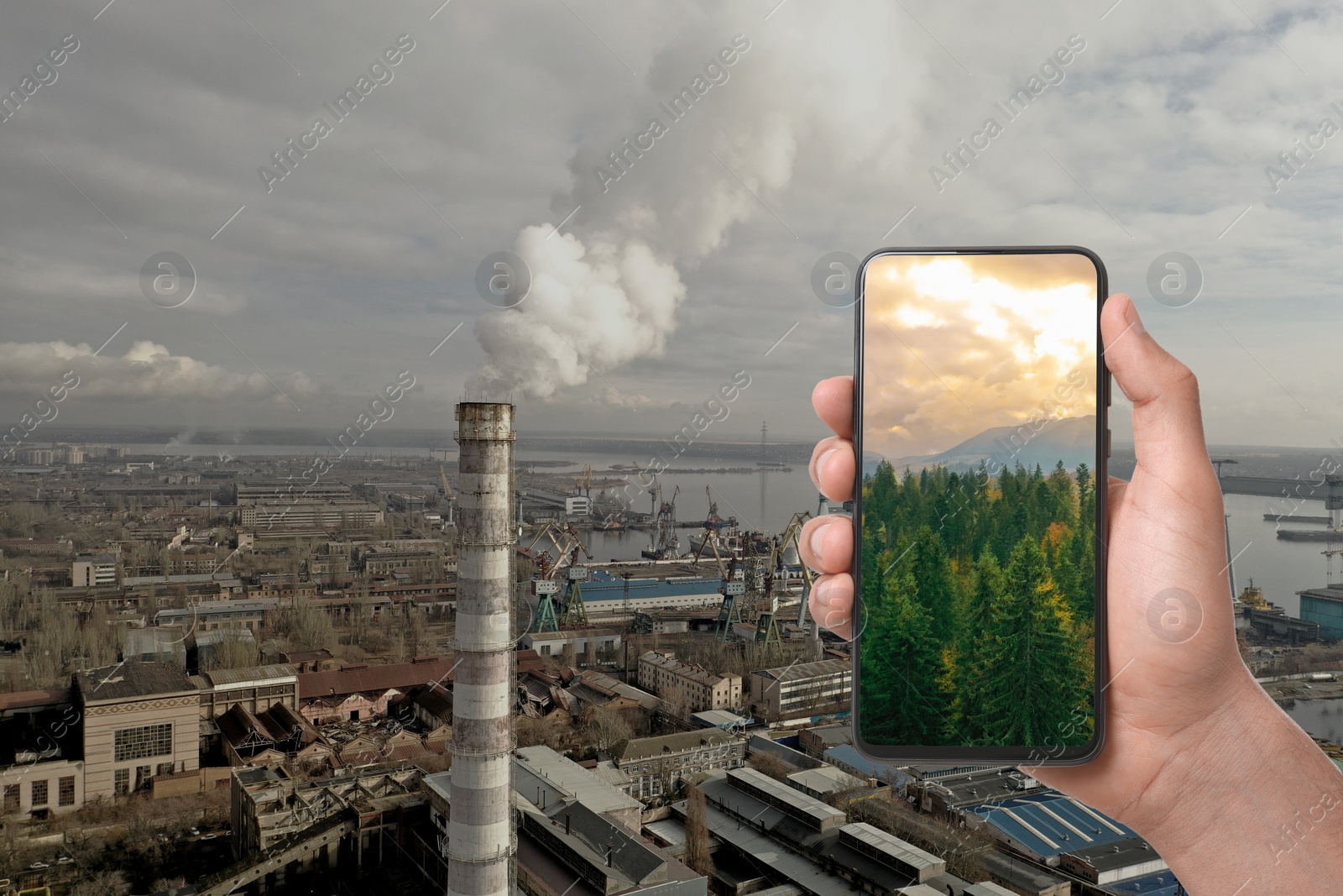 Image of Environmental pollution. Man holding phone with beautiful mountain landscape on screen against industrial factory