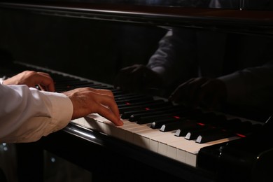 Photo of Man playing grand piano, closeup. Talented musician