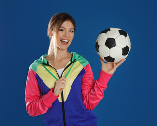 Photo of Happy woman with soccer ball on blue background