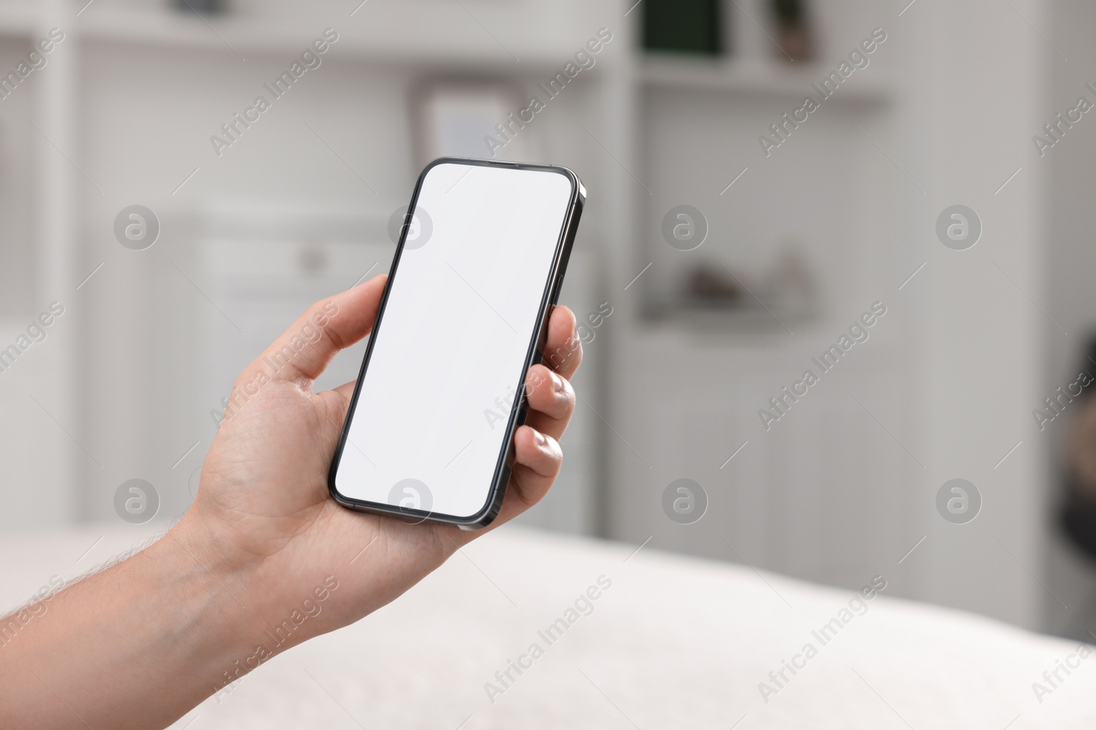 Photo of Man using mobile phone indoors, closeup. Space for text