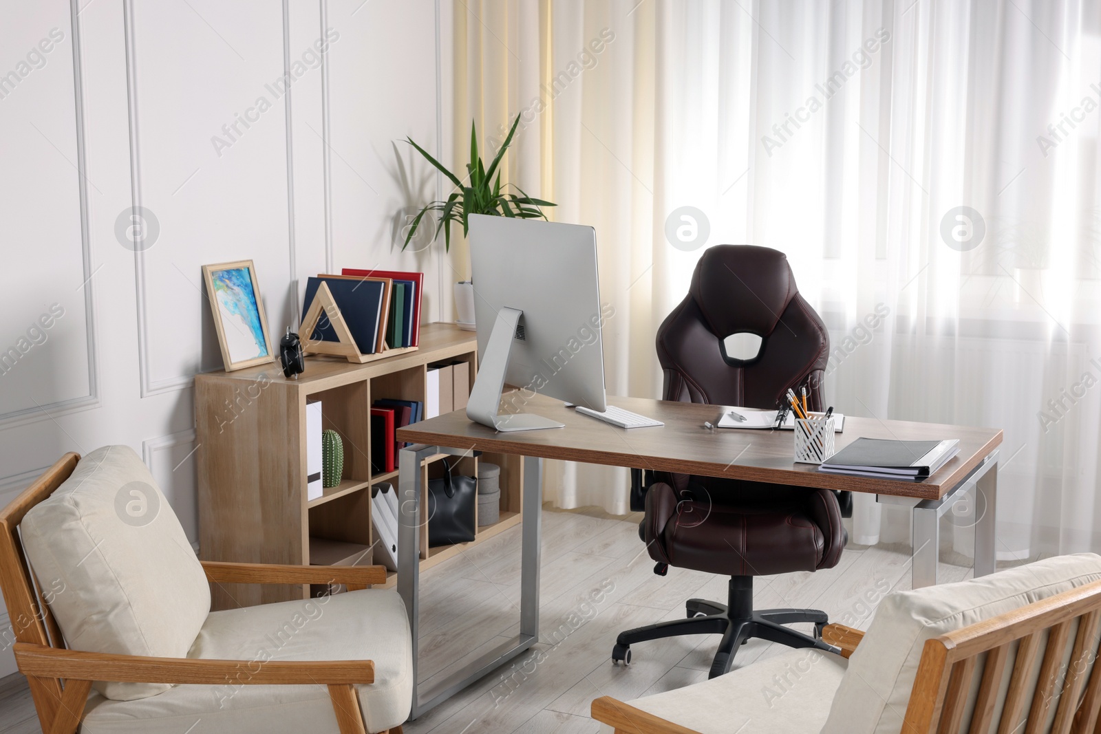 Photo of Receptionist workplace with computer and waiting area. Interior design