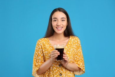 Beautiful woman with cold kvass on blue background. Traditional Russian summer drink