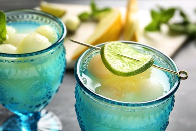 Melon ball cocktail served on table, closeup