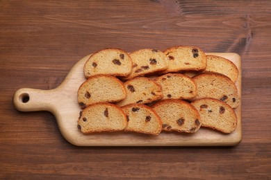 Sweet hard chuck crackers with raisins on wooden table, top view