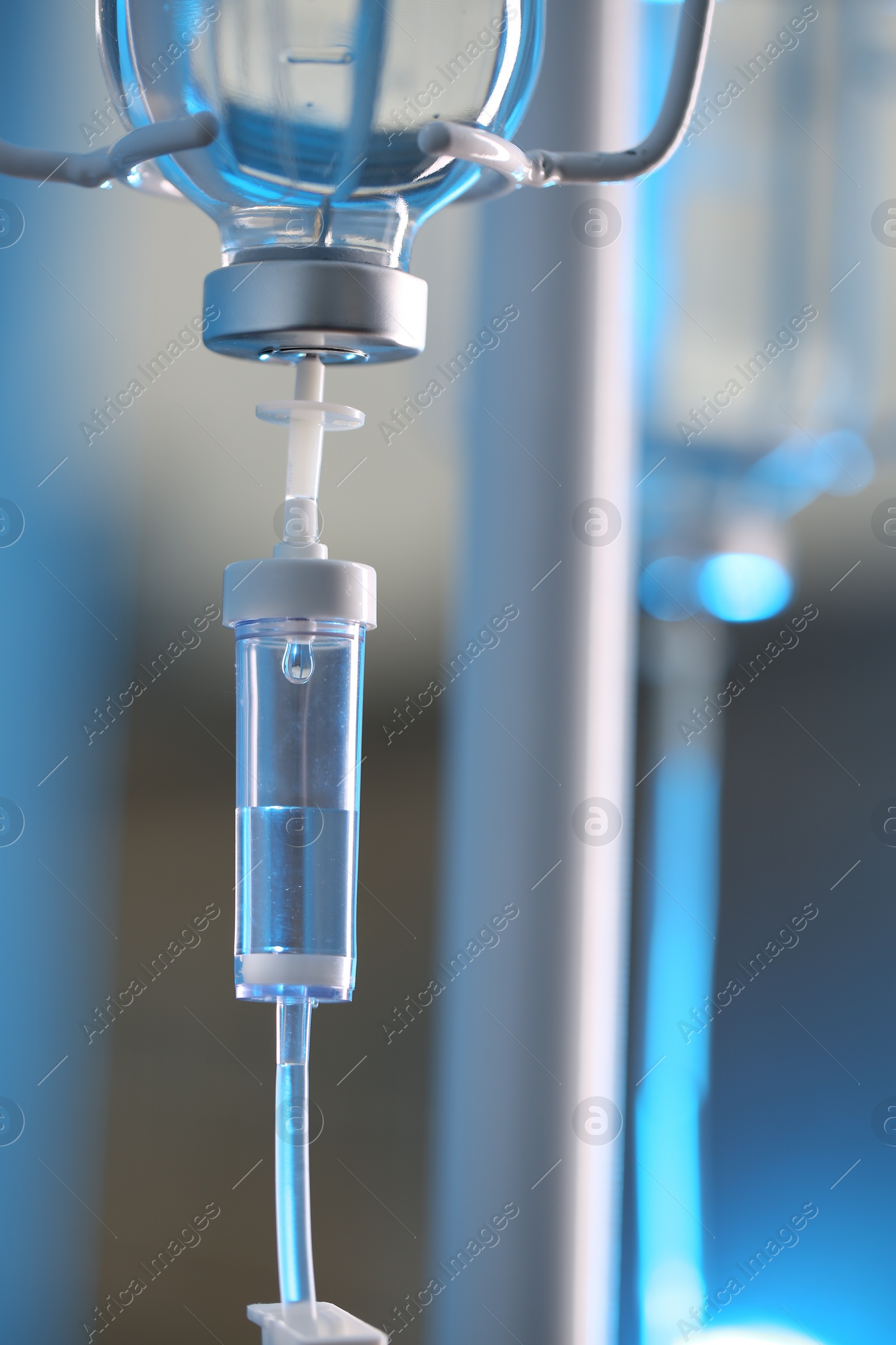 Photo of IV drip chamber against blurred light background