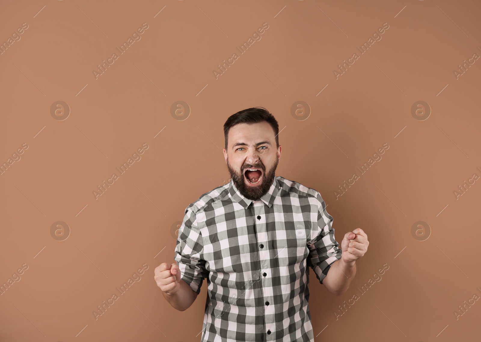 Photo of Portrait of handsome bearded man on color background