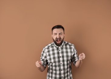 Portrait of handsome bearded man on color background