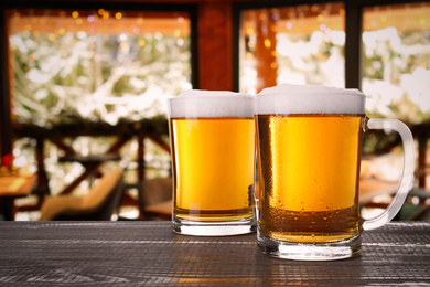 Image of Fresh cold beer on wooden table in pub