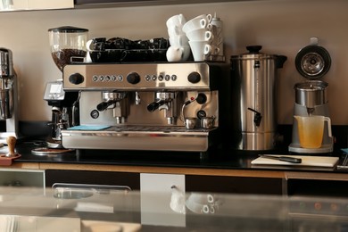 Photo of Professional coffee machine on countertop in cafe