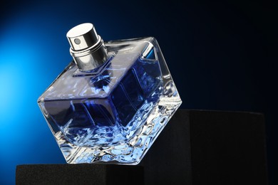 Photo of Luxury men`s perfume in bottle against dark background