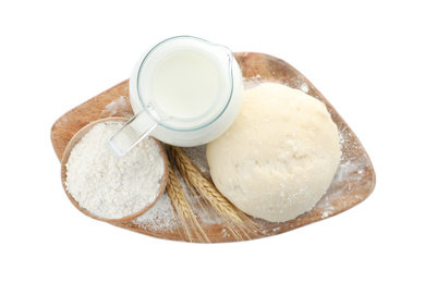 Photo of Board with dough, milk and flour on white background, top view. Cooking pastries