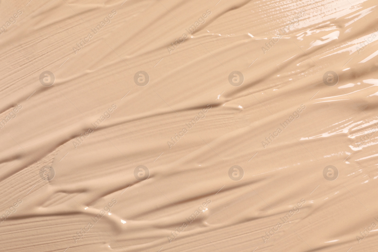 Photo of Texture of skin foundation as background, closeup