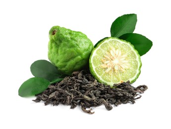 Pile of dry bergamot tea leaves and fresh fruits on white background