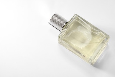 Photo of Luxury men`s perfume in bottle on white background, above view. Space for text