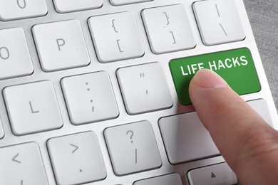 Image of Woman pressing green button with words Life Hacks on computer keyboard, closeup