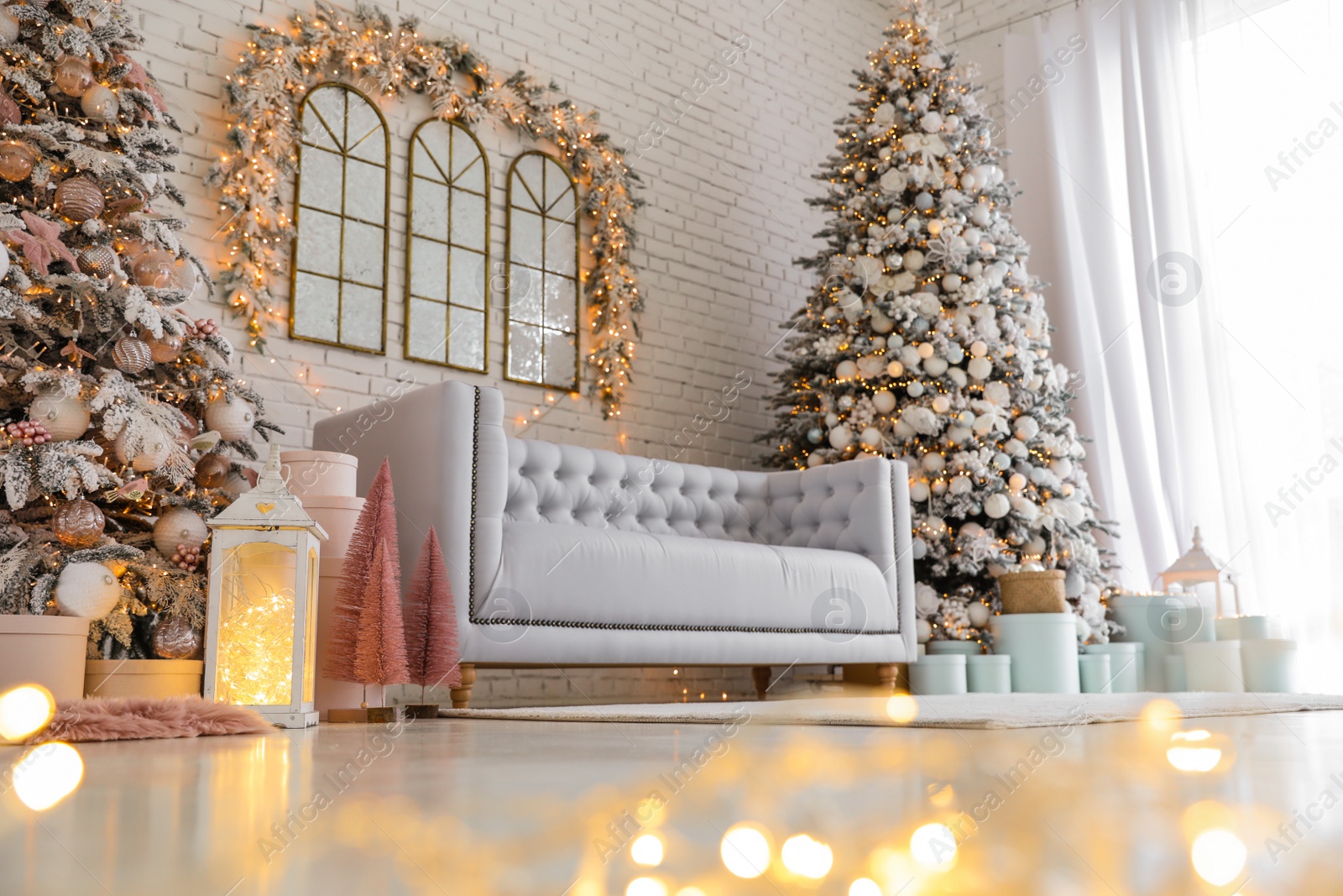 Photo of Beautiful interior of living room with decorated Christmas trees, low angle view