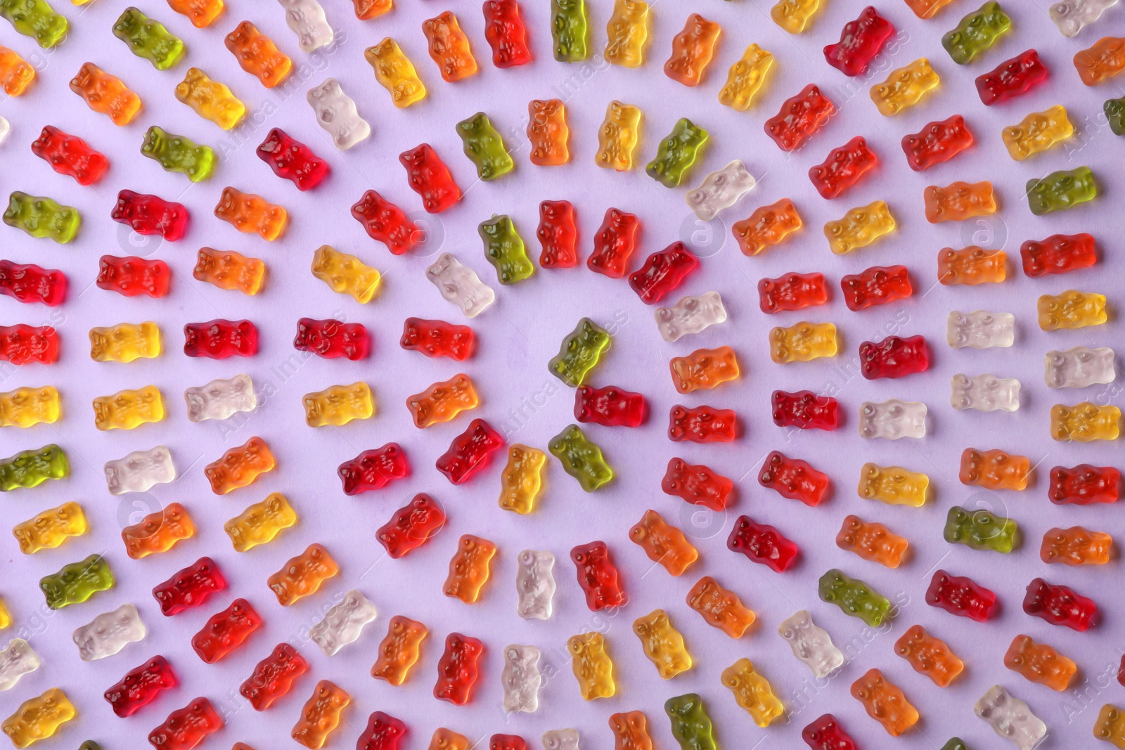 Photo of Flat lay composition with delicious jelly bears on color background