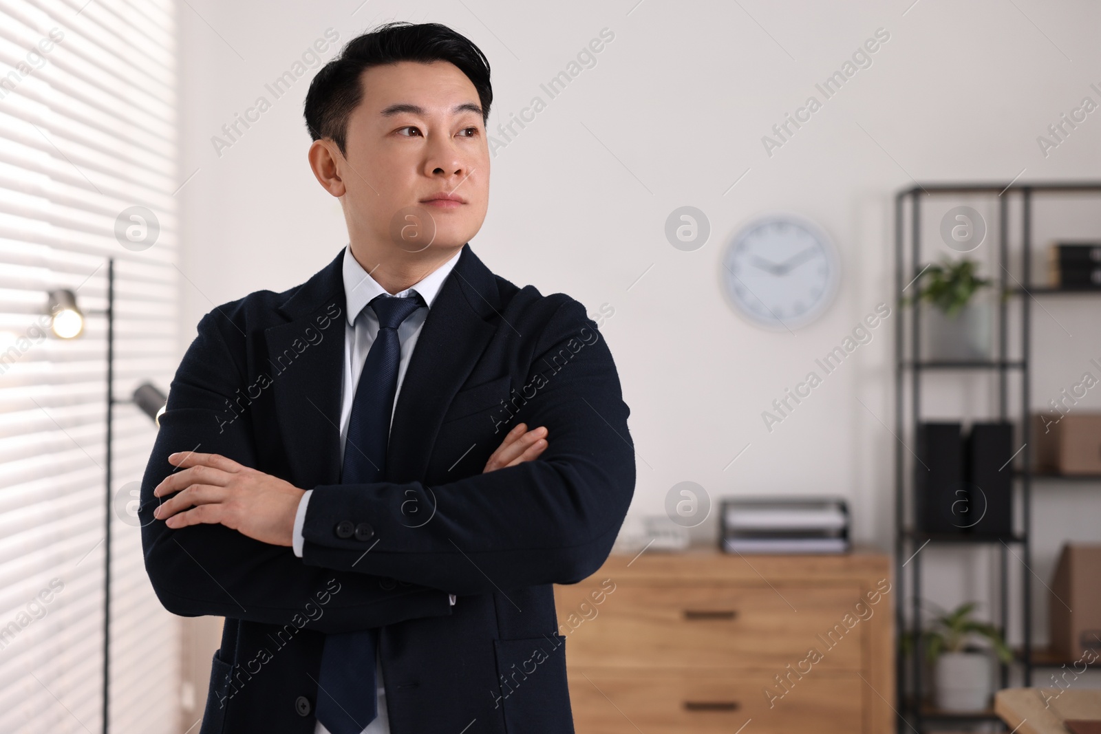 Photo of Portrait of confident notary with crossed arms in office, space for text