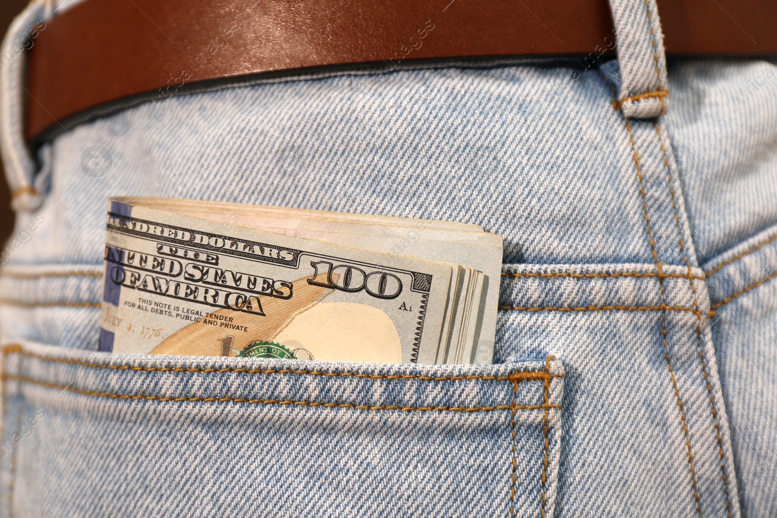 Photo of Dollar banknotes in pocket of jeans, closeup. Spending money