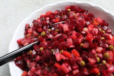 Photo of Delicious fresh vinaigrette salad in bowl, closeup