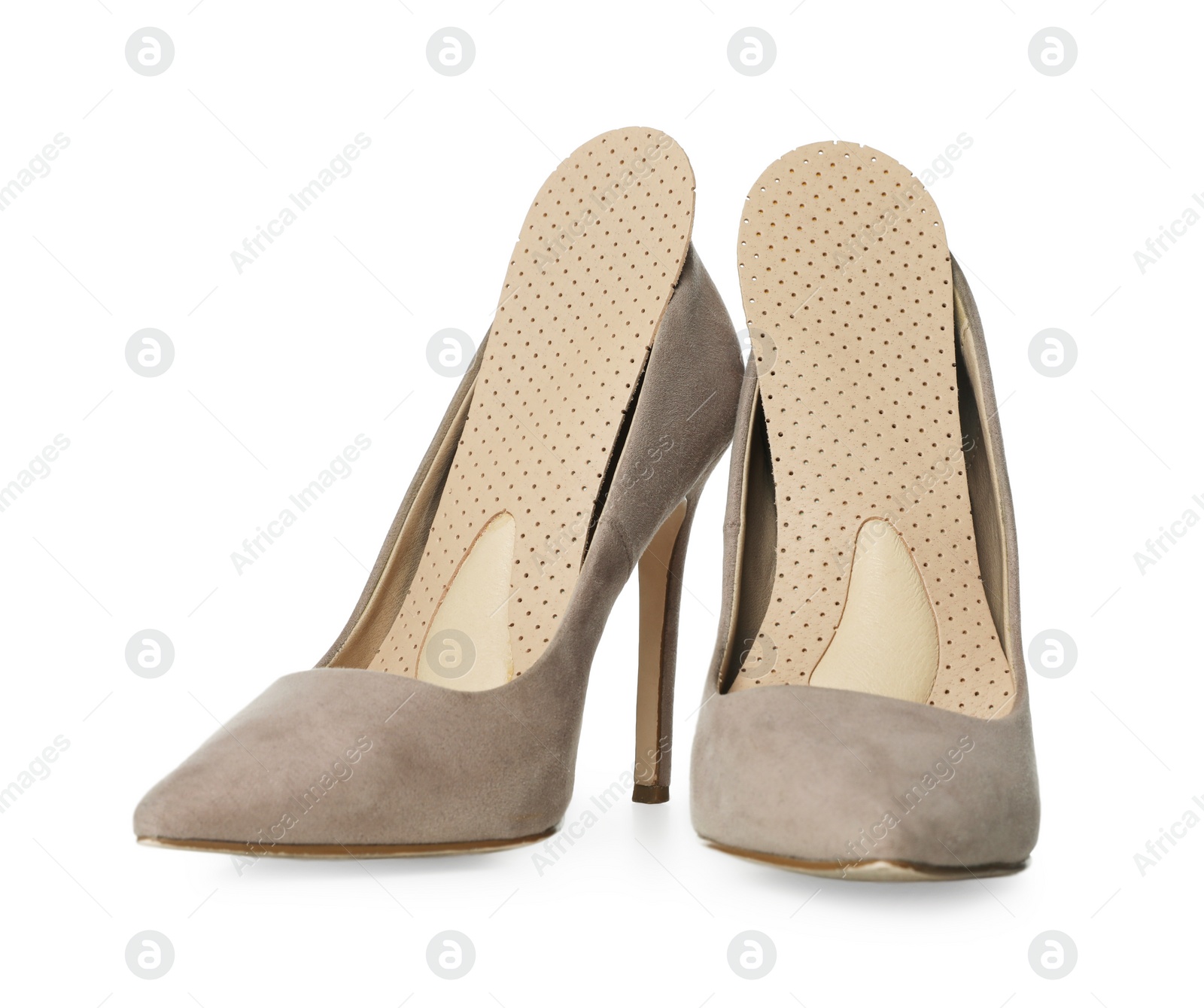 Photo of Orthopedic insoles in high heel shoes on white background