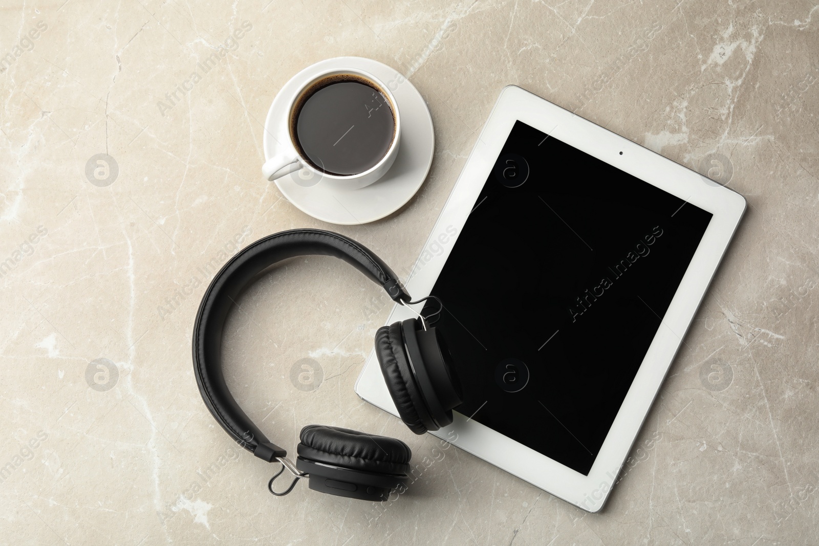 Photo of Flat lay composition with headphones, tablet and cup of coffee on table. Space for text