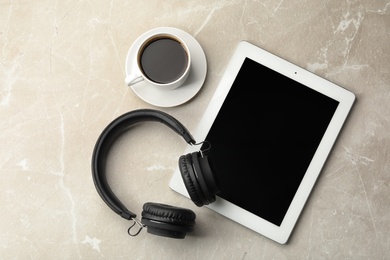 Photo of Flat lay composition with headphones, tablet and cup of coffee on table. Space for text