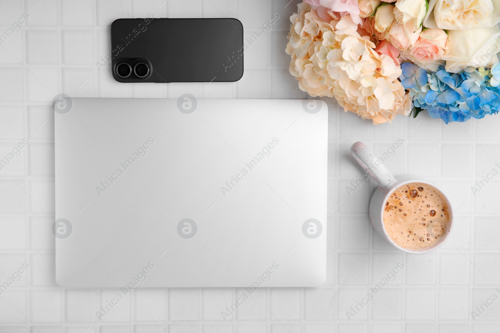 Photo of Flat lay composition with beautiful hydrangea and rose flowers on white tiled table