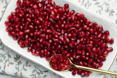 Photo of Ripe juicy pomegranate grains on white table, top view