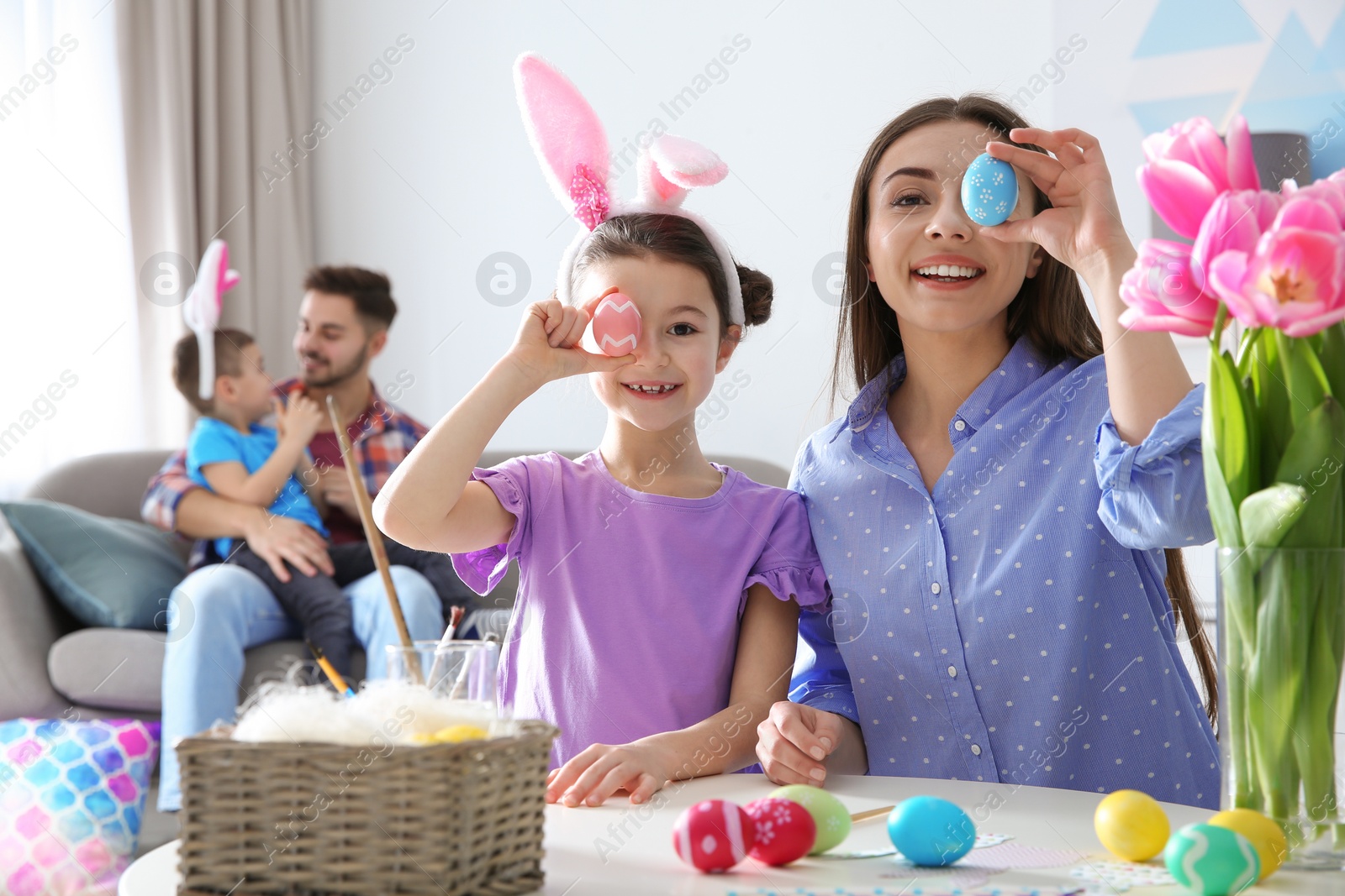 Photo of Happy family preparing for Easter holiday at home