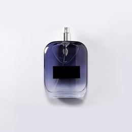 Photo of Luxury men`s perfume in bottle on white background, top view