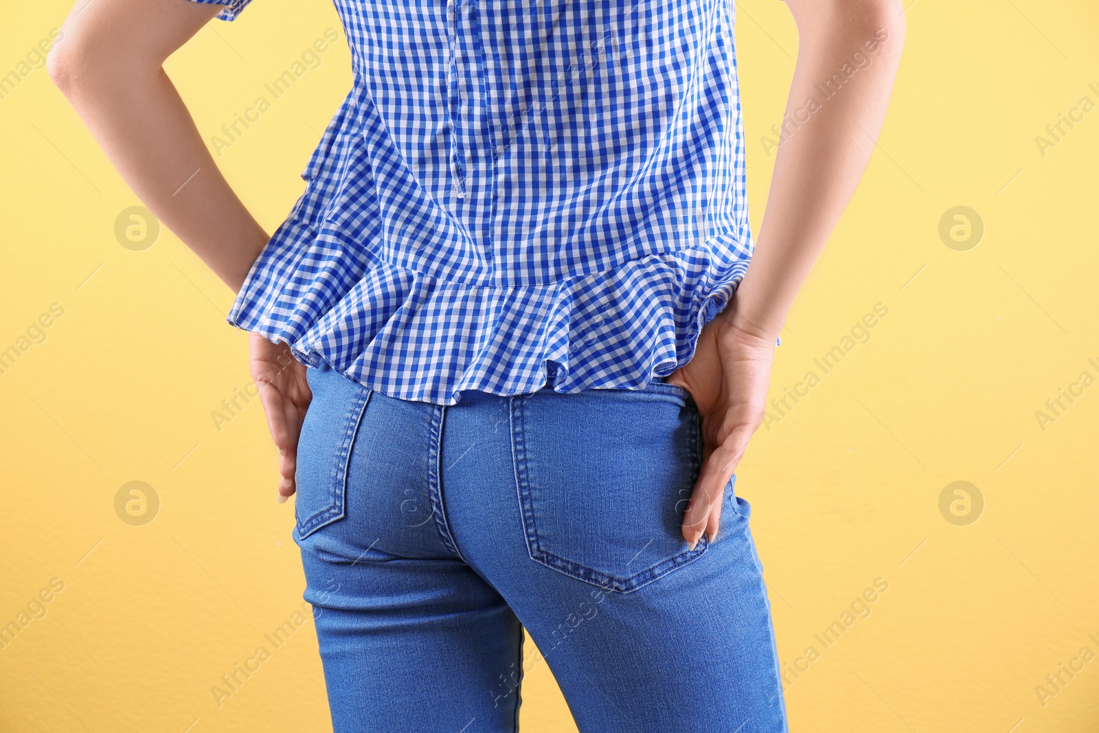 Photo of Woman in stylish blue jeans on color background