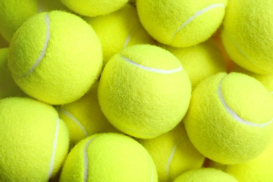 Tennis balls as background, top view. Sports equipment