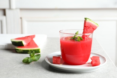 Summer watermelon drink with mint in glass served on table